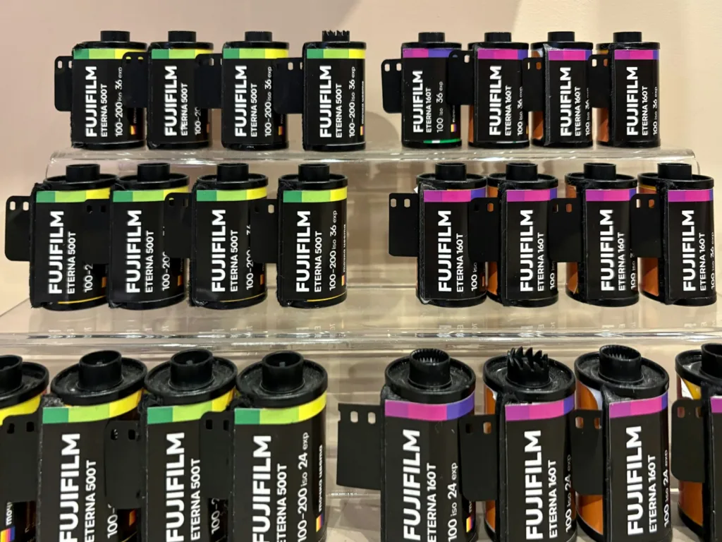 A collection of fujifilm film rolls is on display.